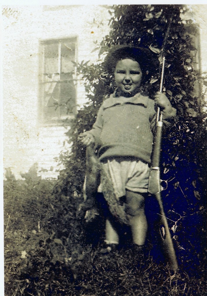 3 year old Charlie, holding the squirrel his Dad shot and had him pose with