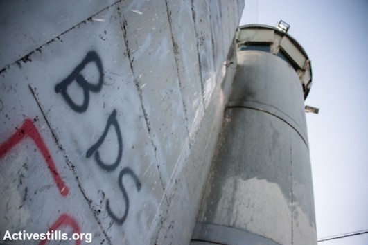 BDS graffiti on Israeli separation wall, Bethlehem, West Bank, June 17, 2014. (Photo by Ryan Rodrick Beiler/Activestills.org)