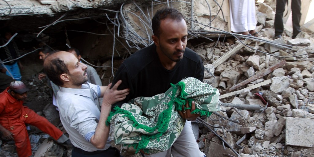 Yemeni rescuers carry the body of a baby girl who was retrieved from the rubble after a building was struck overnight by Saudi-led coalition airstrikes on Feb. 10, 2016, in the capital, Sanaa.