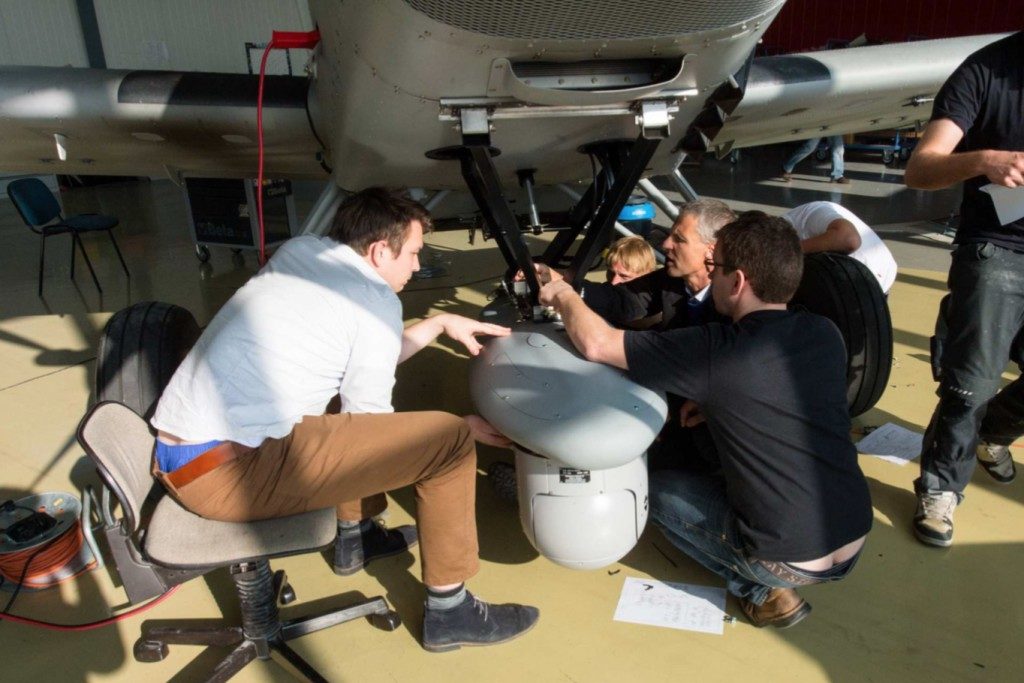 Airborne technicians work on installing retractable surveillance gear. Photo obtained by The Intercept