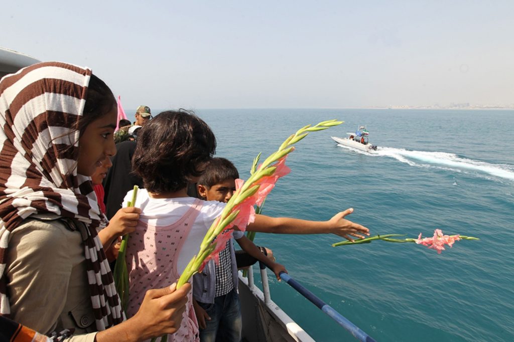  Iranian children throw flowers into the sea as part of a 24th anniversary commemoration of the downing of Iran Air flight 655. (ATTA KENARE/AFP/GettyImages)