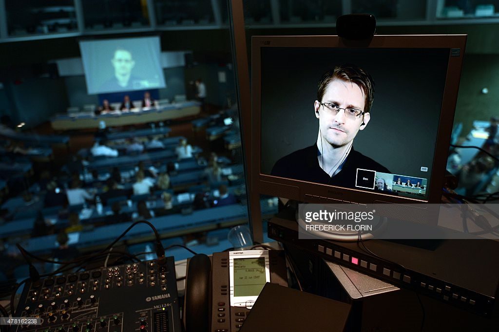 NSA former intelligence contractor Edward Snowden is seen via live video link from Russia on a computer screen during a parliamentary hearing on the subject of 'Improving the protection of whistleblowers', on June 23, 2015, at the Council of Europe in Strasbourg. Snowden, who has been granted asylum in Russia, is being sought by Washington which has branded him a hacker and a traitor who endangered lives by revealing the extent of the NSA spying program. AFP PHOTO / FREDERICK FLORIN (Photo credit should read FREDERICK FLORIN/AFP/Getty Images)