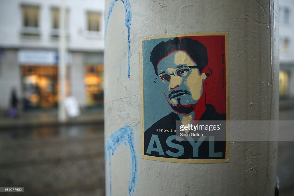 DRESDEN, GERMANY - JANUARY 05: A sticker demanding asylum for whistleblower and former NSA worker Edward Snowden hangs stuck to a lamppost on January 5, 2015 in Dresden, Germany. Many Germans favour granting Snowden asylum in Germany following reports that the NSA has conducted extensive eavesrodpping operations in Germany and even listened in on the mobile phone of German Chancellor Angela Merkel. (Photo by Sean Gallup/Getty Images)