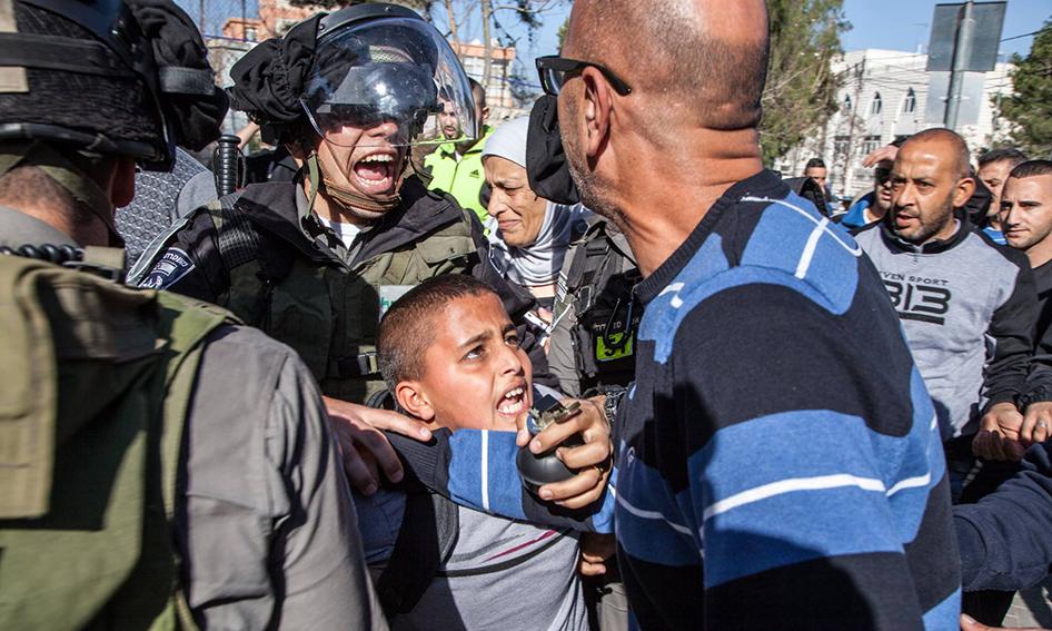 Border police arrest Ahmad Abu Sbitan, 11, in front of his school in East Jerusalem, July 2015. The police accused him of throwing a stone at them. Photo by Majd Gaith.