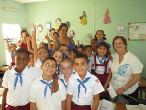 Students and their teacher at the Juan Blandino Elementary School in Regla happily pose for a picture with Richmond visitor Tarnel Abbott. – Photo courtesy of Tarnel Abbott