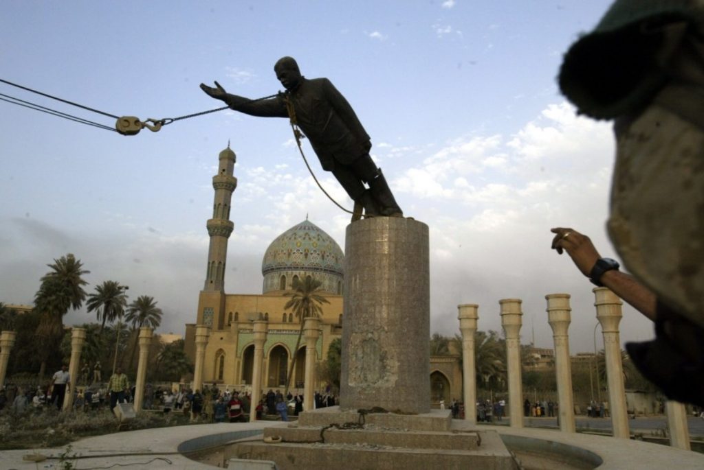  A statue of Saddam Hussein is pulled down by U.S. troops and Iraqi civilians in Firdaus Square, in downtown Baghdad in this April 9, 2003, photo.  (AP Photo/Jerome Delay)