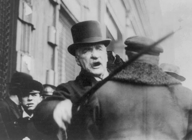 Mega-banker J. P. Morgan hitting a photographer with his cane.