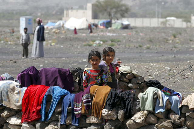In Yemen, internally displaced children stand outside their family tent after the family fled their home in Saada province and found refuge in Darwin camp, in the northern province of Amran. Photo credit: UNHCR/Yahya Arhab