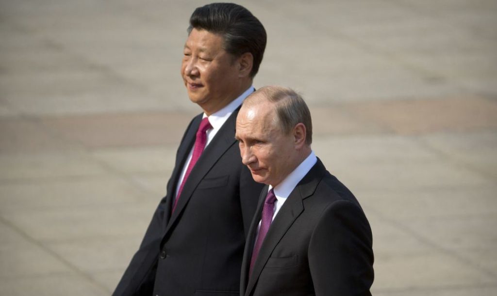 Chinese President Xi Jinping, left, walks with Russian President Vladimir Putin during a welcoming ceremony at the Great Hall of the People in Beijing, Saturday, June 25, 2016. (AP Photo/Mark Schiefelbein)