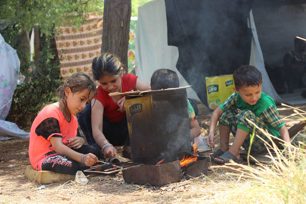 Children prepare a fire for cooking in Aleppo city, Syria. As of 2 August 2016, children are again facing terrible threats from new intense attacks and fighting in the western parts of the city. Photo: UNICEF/Khuder Al-Issa