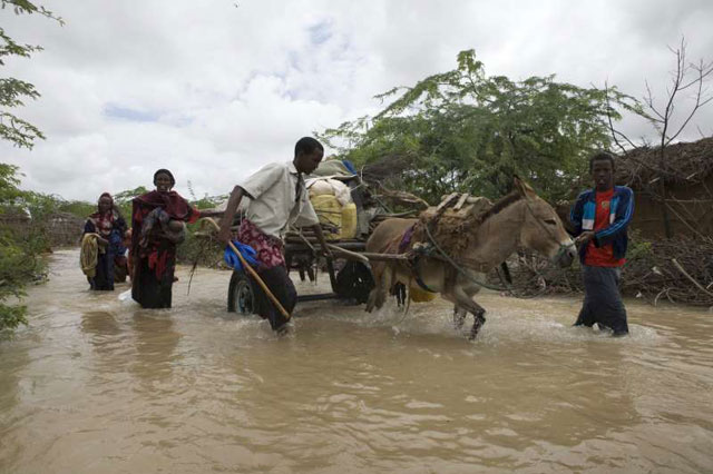 Somali refugees flee flooding in Dadaab, Kenya. The Dadaab refugee camps are situated in areas prone to both drought and flooding, making life for the refugees and delivery of assistance by UNHCR challenging. Credit:©UNHCR/B.Bannon