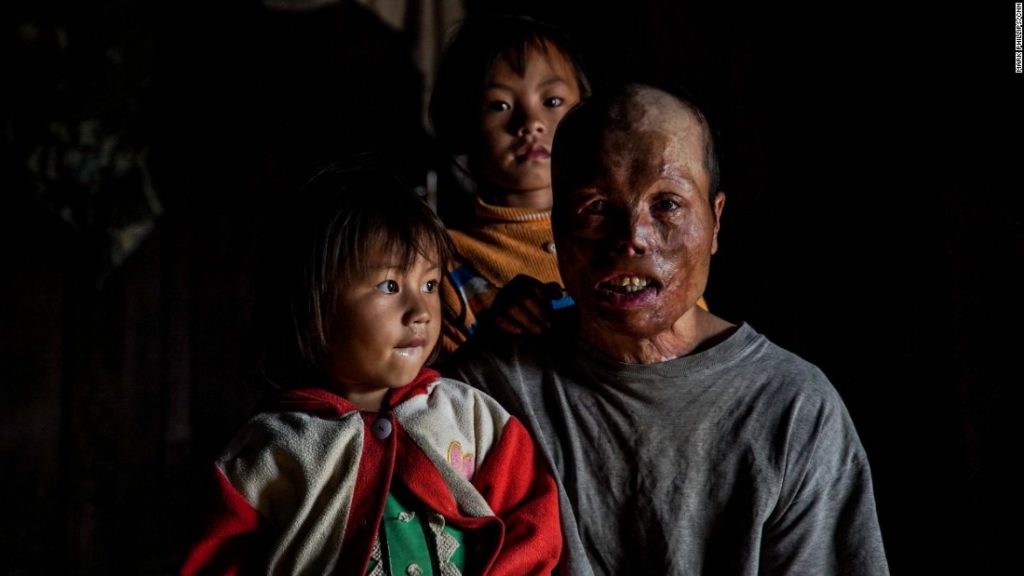 Yei Yang with two of his three children. Xieng Khoung, Laos (CNN)