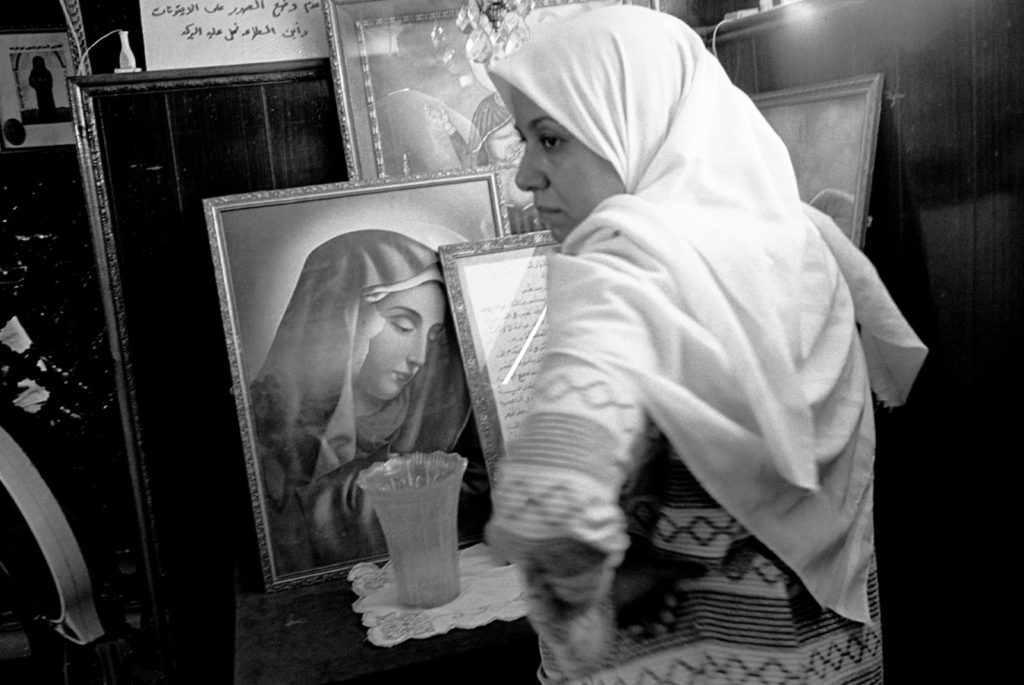 A Muslim woman asking for protection from black magic inside the shrine of Abba Ruwais, a Copt saint, Cairo, Egypt, 1997. Abbas/Magnum Photos