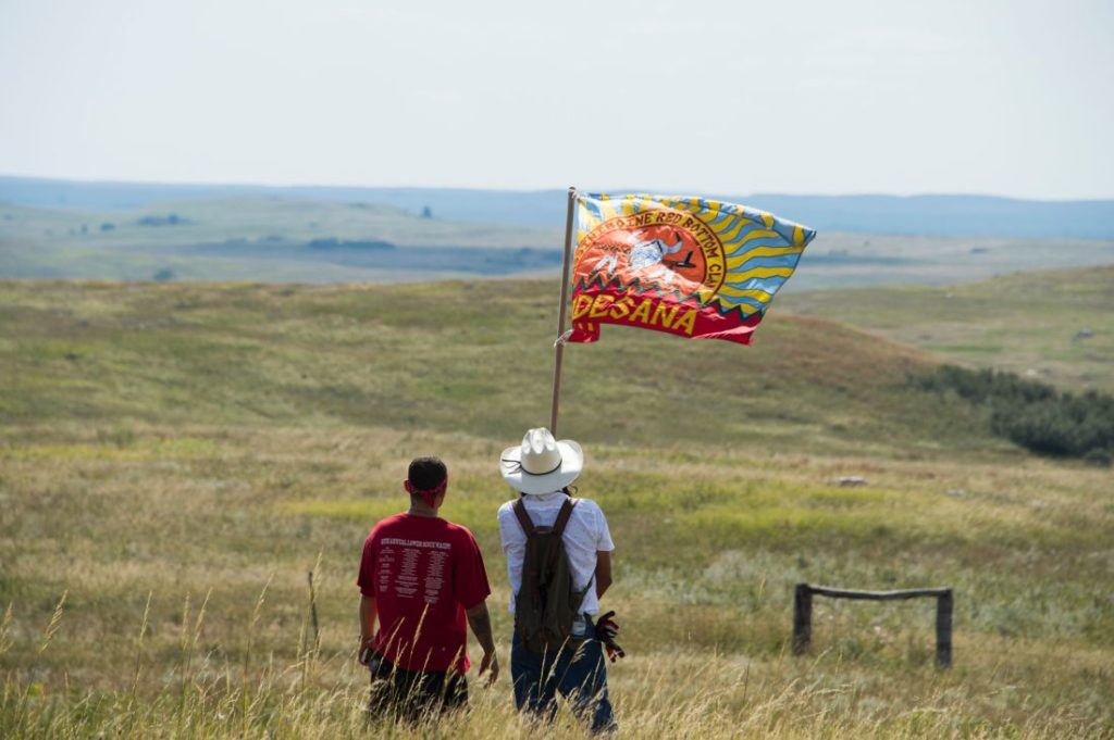 Native American protestors wave a clan flag over land designated for the Dakota Access Pipeline, on September 3, 2016, near Cannon Ball, North Dakota. ROBYN BECK—AFP/Getty Images