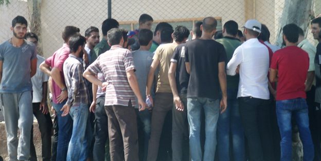 Above are rebel fighters who departed al-Moaddamiyeh on 9/8/2016 having their names registered and checked by the Syrian army. The rebels are promised a ‘clean slate’ with the government “in most cases.”  When asked what that language meant the observer was advised:  “If we learn that any of them organized a car bombing or something similar, we will continue to have a problem with him and he will face justice.” (Photo: Franklin Lamb 9/8/2016)