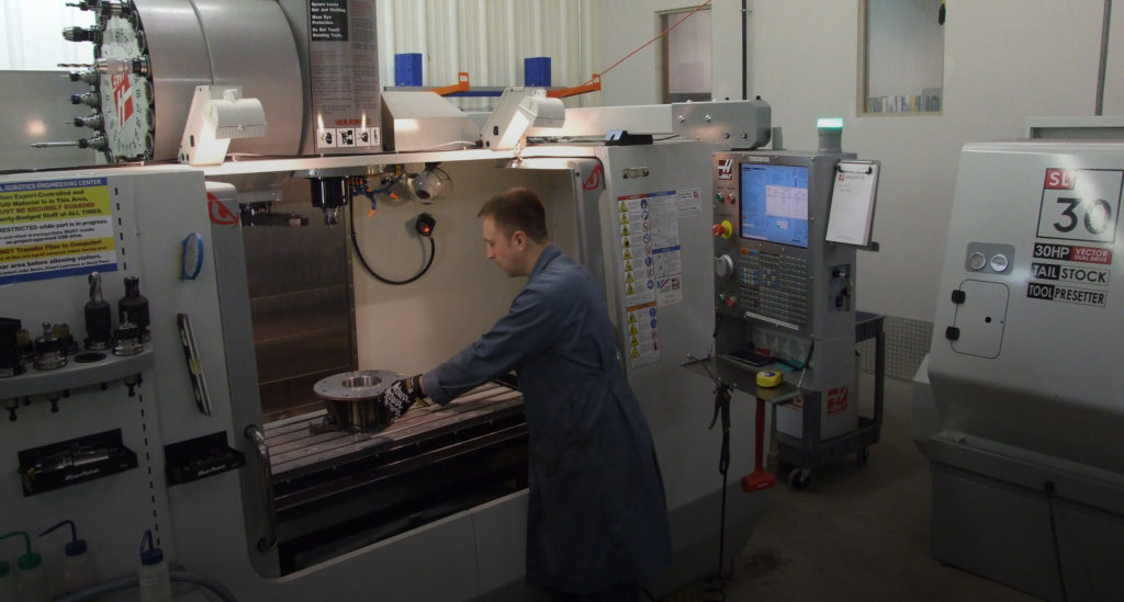 A technician at a modern machine shop workstation at the National Robotics Engineering Center. (Photo: CC BY-SA 3.0 by Rob NREC)