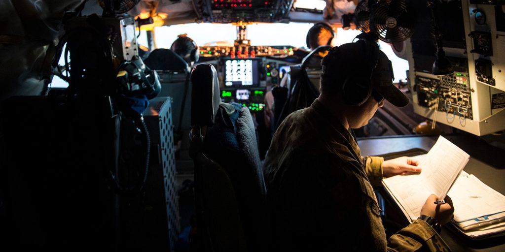 A member of the U.S. Air Force looks over flight paperwork inside a KC-135 Stratotanker flying over Iraq on March 17, 2016, in support of Operation Inherent Resolve. Staff Sgt. Corey Hook/U.S. Air Force