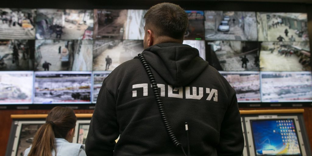 People observe surveillance cameras on screens inside the Jerusalem Police’s Mabat 2000 unit on Nov. 17, 2015, in Jerusalem. Photo: Ohad Zwigenberg