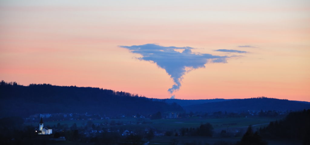 The sun sets on the Leibstadt nuclear power plant, as seen from Dörflingen, Switzerland (Photo by Hansueli Krapf, edited, CC BY-SA 3.0)