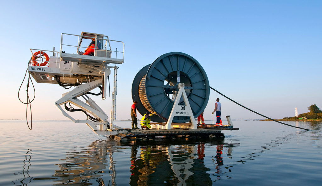 Workers lay undersea cables near Hiddensee Island, Germany. Photo: Ullstein Bild/Getty Images