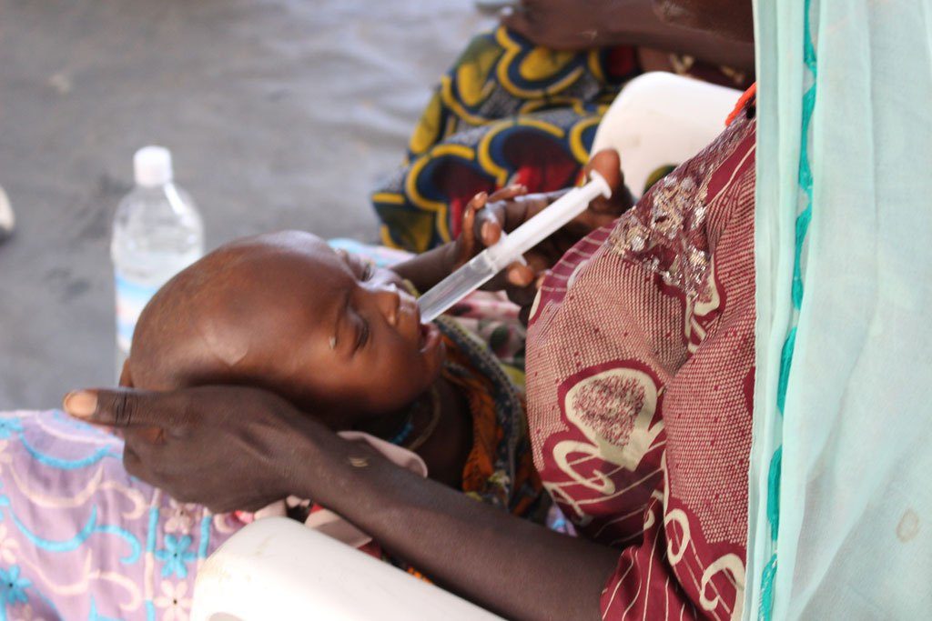 A severely malnourished child receives treatment in a clinic in Banki, north-east Nigeria. He is receiving water with sugar and food supplements to increase his body weight.  Photo: OCHA/O.Fagan