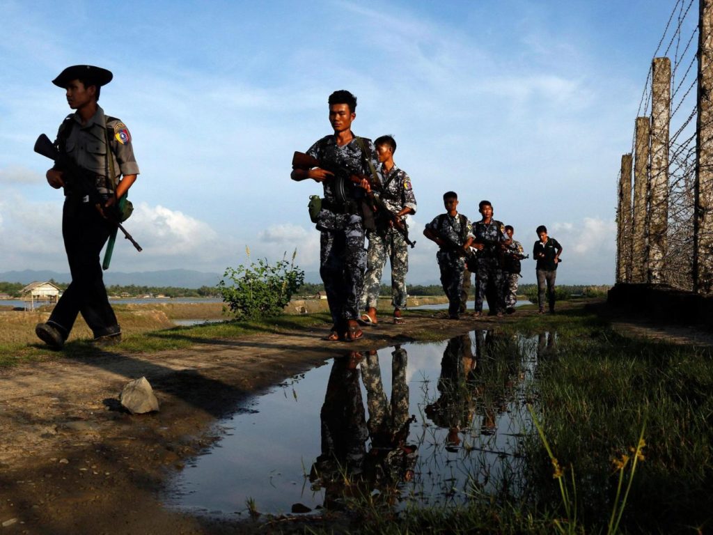 Myanmar police officers patrol along the border fence between Myanmar and Bangladesh in Maungdaw, Rakhine State, Myanmar, Friday, 14 October, 2016 AP