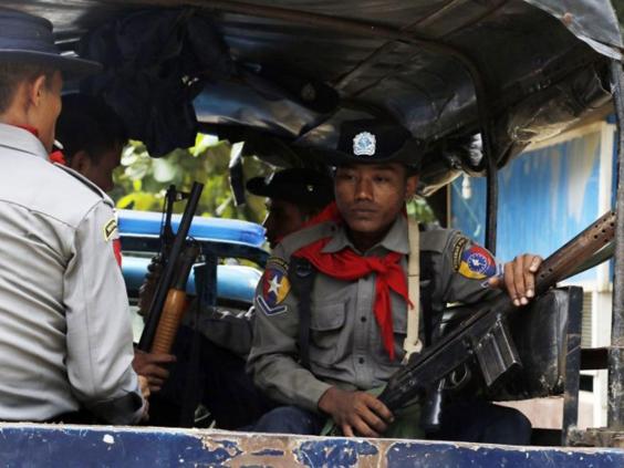 Burmese police officers sit in a truck as they provide security in Maungdaw, Rakhine State, Burma, a border town with Bangladesh on Thursday, 13 October, 2016. Just five months after her party took power, Burma's Nobel Peace Prize-winning leader, Aung San Suu Kyi, is facing international pressure over recent reports that soldiers have been killing, raping and burning homes of the country's long-persecuted Rohingya Muslims (AP)