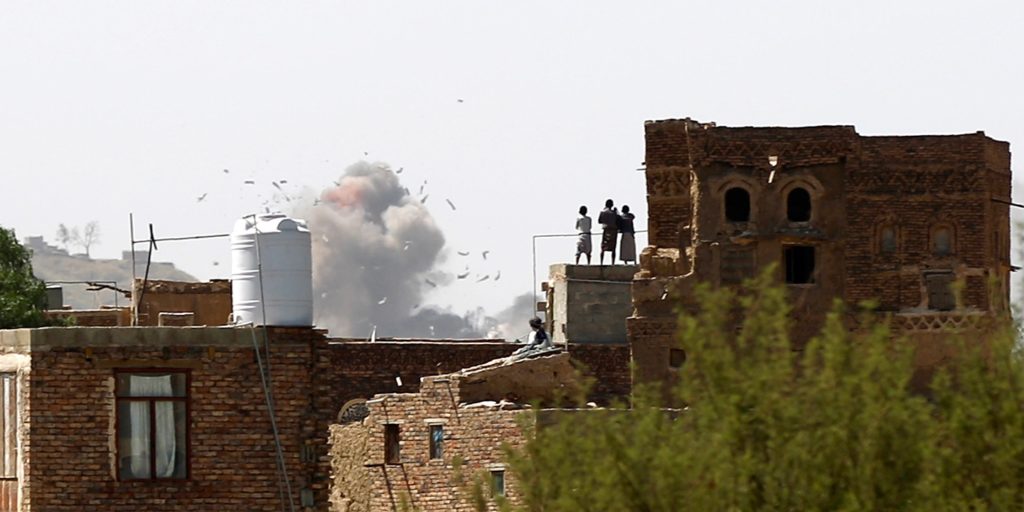 Yemenis stand on a rooftop looking at smoke billows from a building following an air strike reportedly carried out by the Saudi-led coalition in Sanaa, Yemen, on Sept. 25, 2016. Mohammed Huwais/AFP/Getty Images