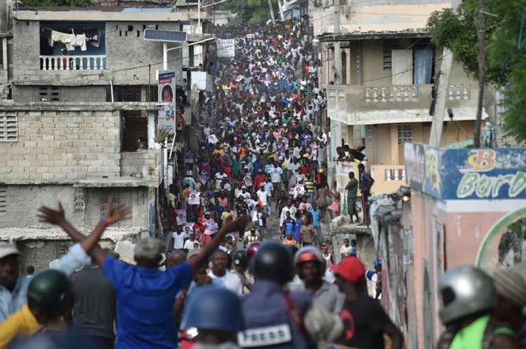 Haitians fill the streets of Port au Prince to protest election fraud – again. – Photo: Hector Retamal, AFP